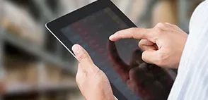 Manager checking warehouse inventory on a tablet